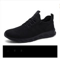 Men's black and white breathable mesh sneakers with lace-up closure and round toe design