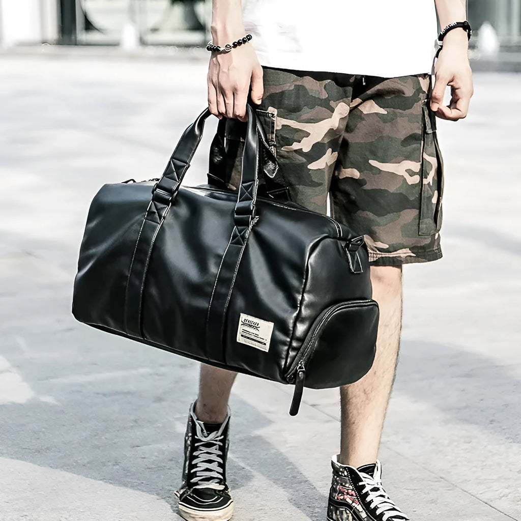 Black large capacity sports training bag with waterproof PU leather, showing handle and zipper details for gym and travel use