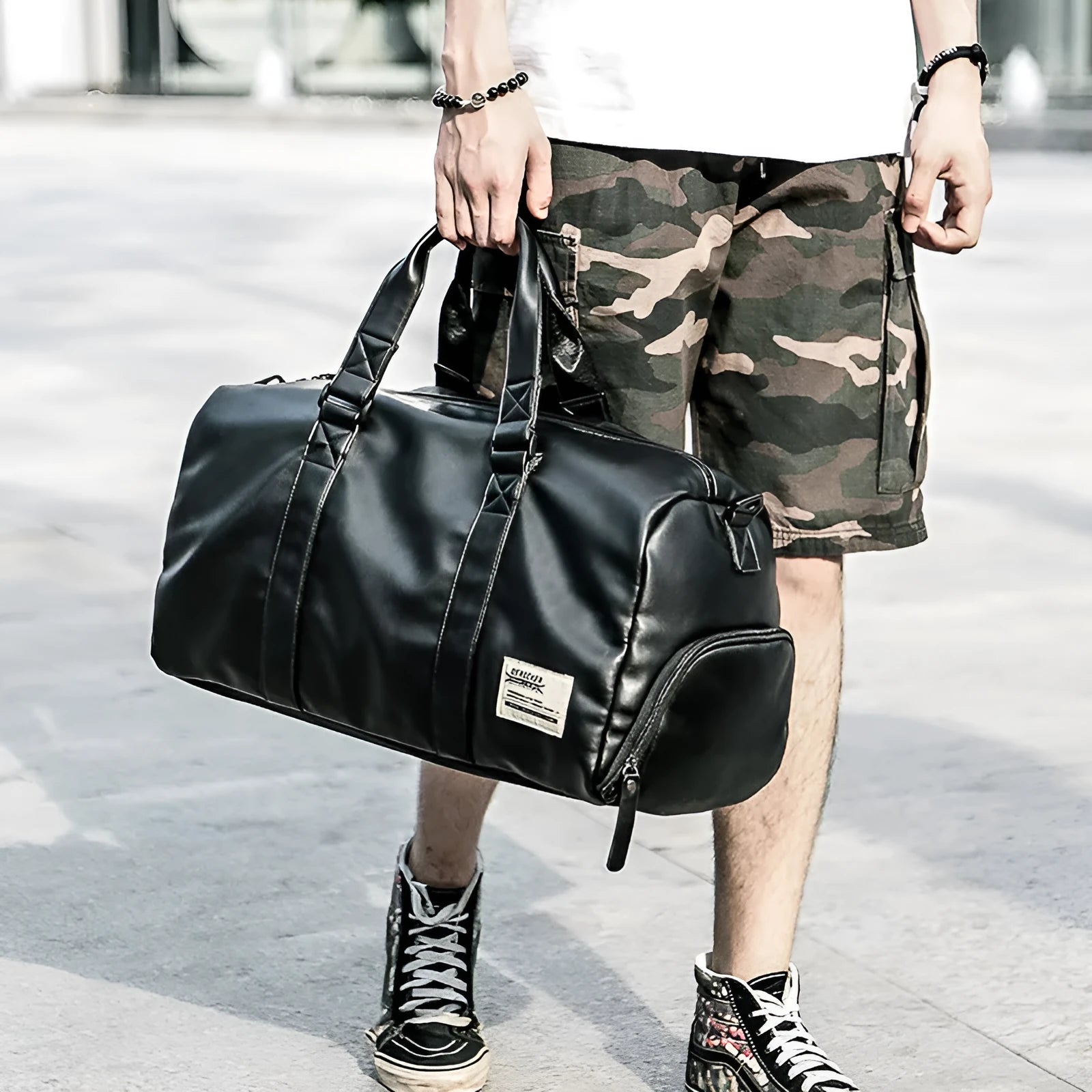 Black large capacity sports training bag with waterproof PU leather, showing handle and zipper details for gym and travel use