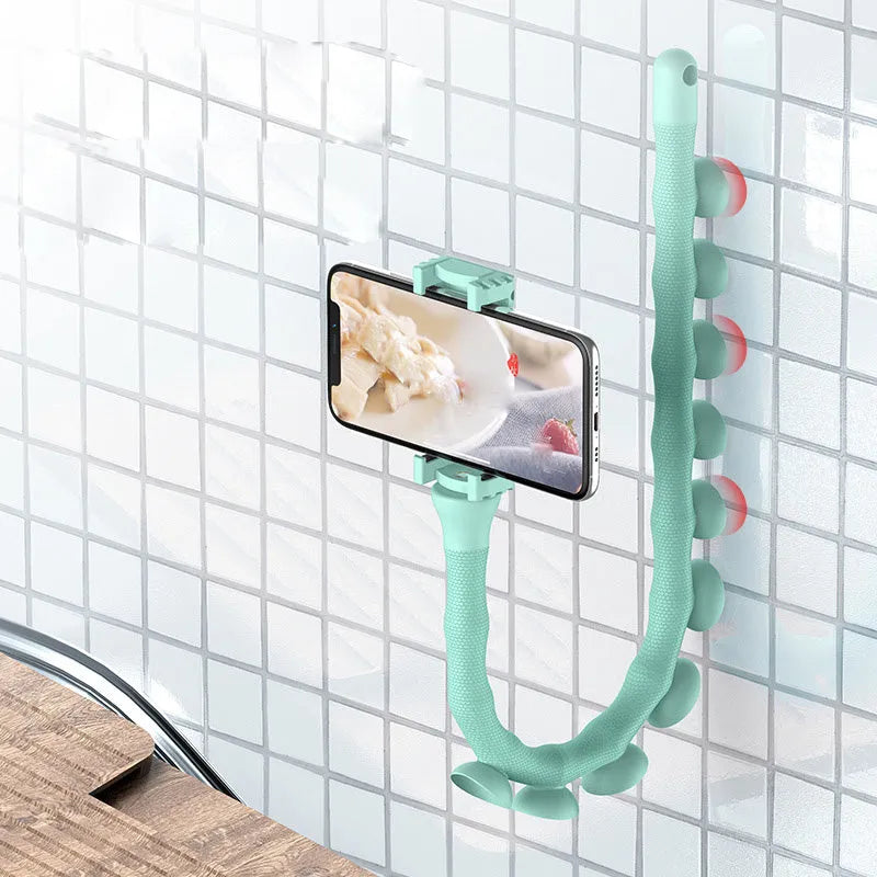 Black flexible arm phone holder with suction cup base bent into an S-shape, holding a mobile phone.