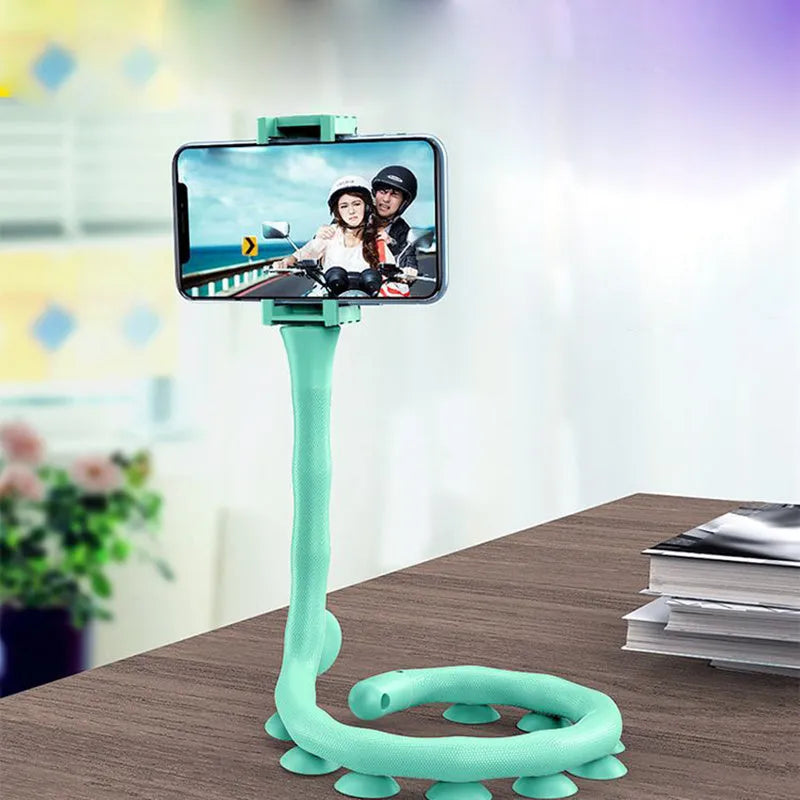 Black flexible arm phone holder with suction cup base bent into an S-shape, holding a mobile phone.