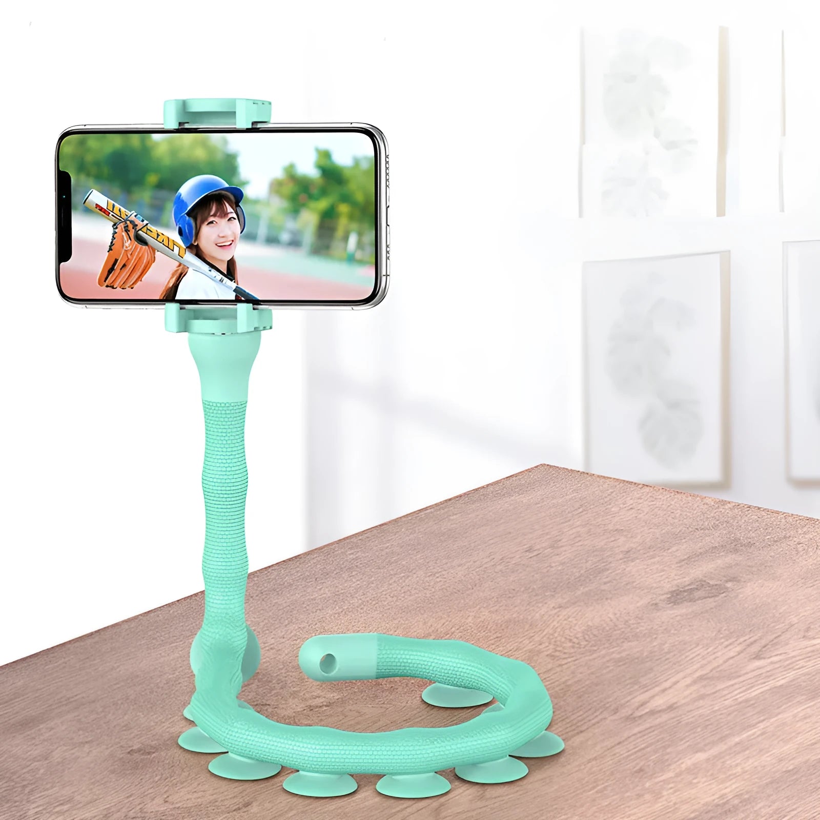 Black flexible arm phone holder with suction cup base bent into an S-shape, holding a mobile phone.