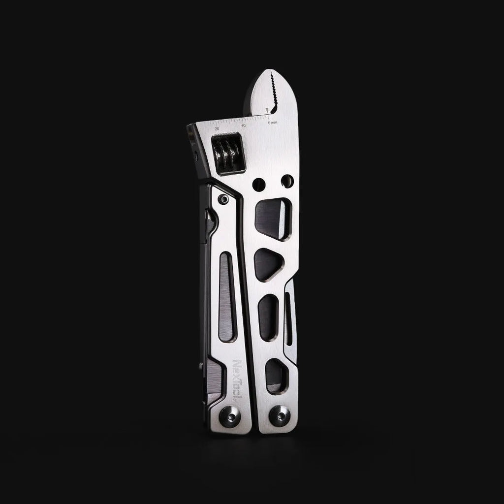 White stainless steel multi-function tool with wrench, knife and needle nose pliers functions