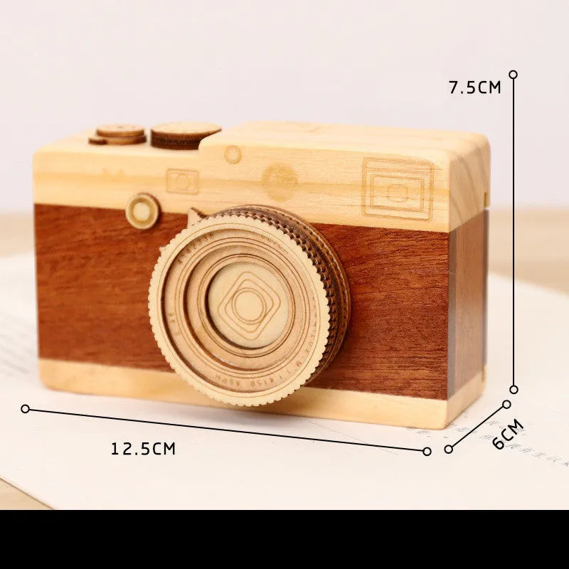 Camera-shaped wooden music box with rotating mechanism on pine wood base