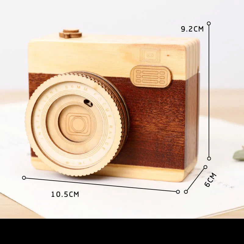 Camera-shaped wooden music box with rotating mechanism on pine wood base
