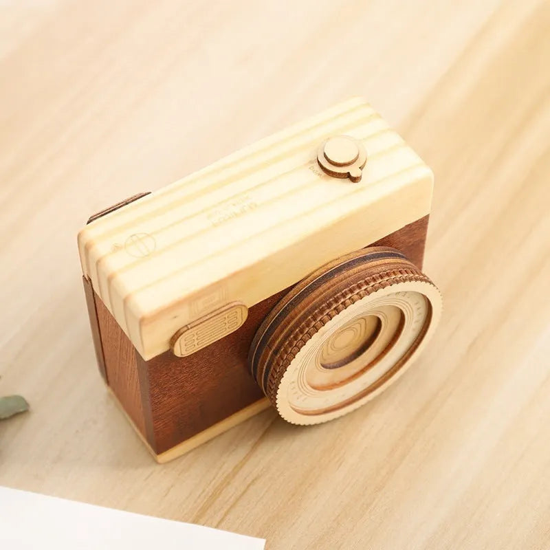 Camera-shaped wooden music box with rotating mechanism on pine wood base