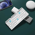 Silver white folding Bluetooth keyboard propping up smartphone with aluminium alloy housing