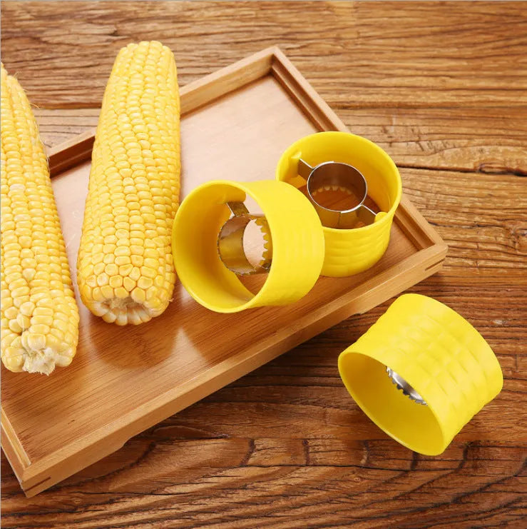 Yellow corn-shaped manual corn grinder thresher kitchen gadget on a wooden surface