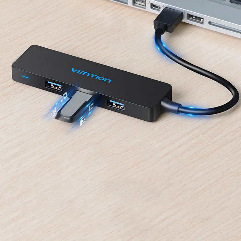 Black four-port USB 3.0 hub with a short 0.15m cable connected to a laptop