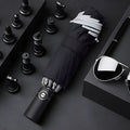 Black automatic reverse umbrella with reflective cloth, showing plastic non-slip handle and three-fold design