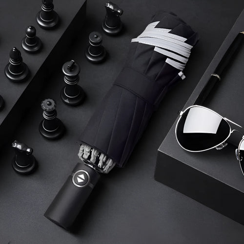 Black automatic reverse umbrella with reflective cloth, showing plastic non-slip handle and three-fold design