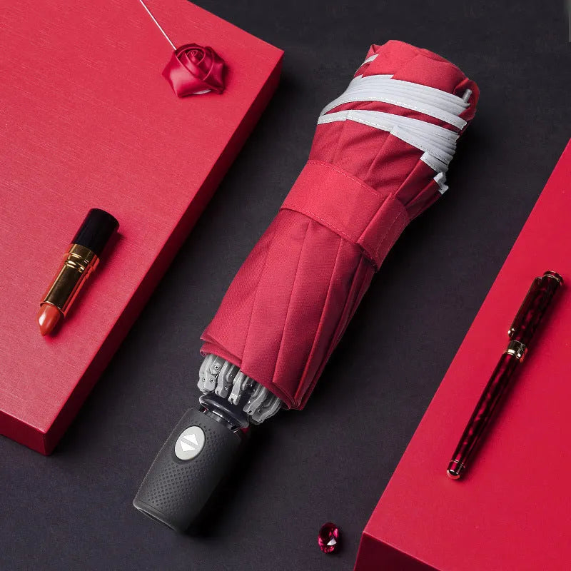 Black automatic reverse umbrella with reflective cloth, showing plastic non-slip handle and three-fold design
