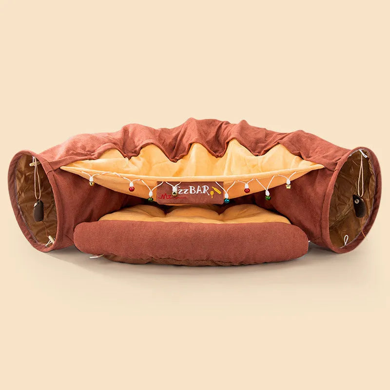 Collapsible cloth cat tunnel folded flat next to a cat, showing Coffee colour option.