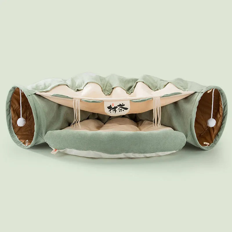 Collapsible cloth cat tunnel folded flat next to a cat, showing Coffee colour option.