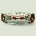 Collapsible cloth cat tunnel folded flat next to a cat, showing Coffee colour option.