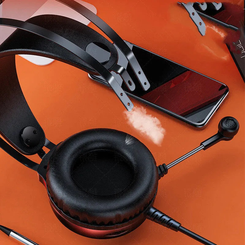 Black wired PC headset with microphone, over-ear protein earmuffs, and a long cable with a 3.5mm plug.