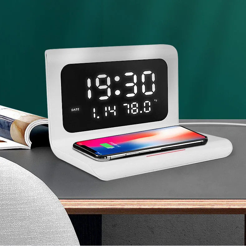 White wireless charging alarm clock showing time, date, temperature and calendar display on bedside table