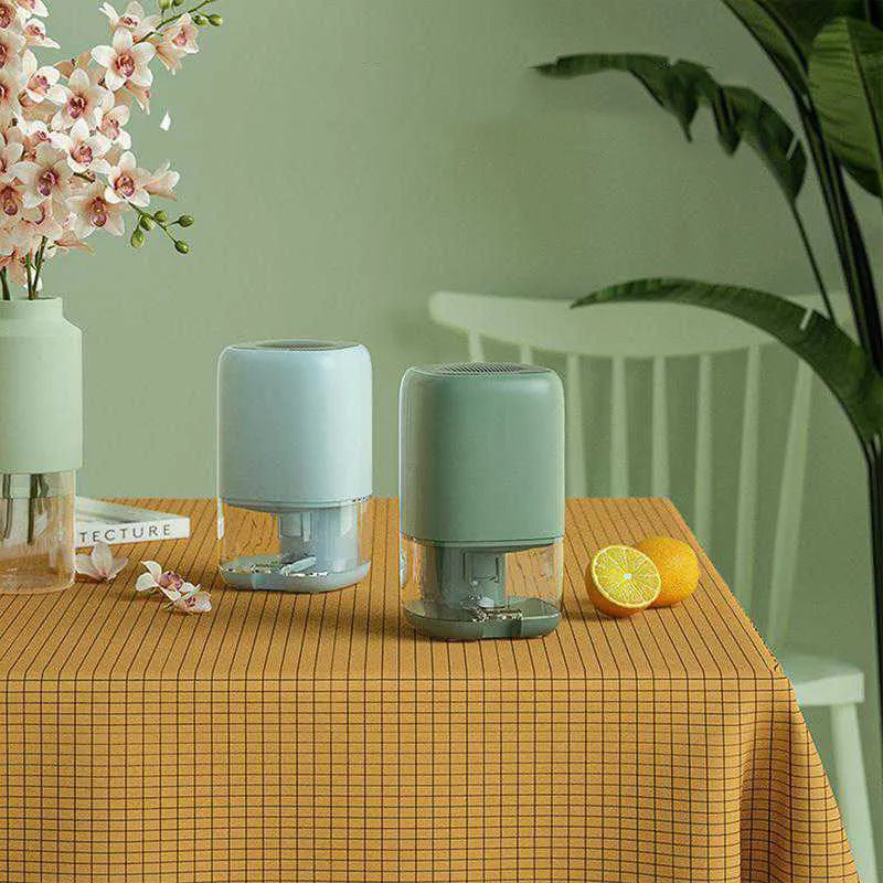 Portable dehumidifier in blue with 0.7L water tank, shown with UK power plug.
