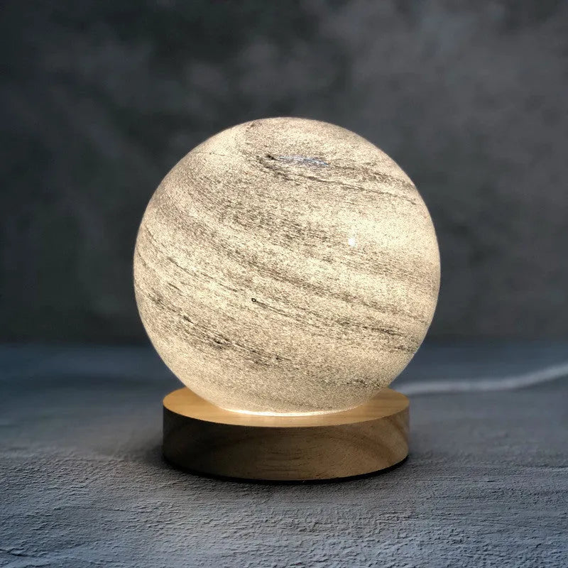 Nordic style bedside table lamp with glass shade on a table.
