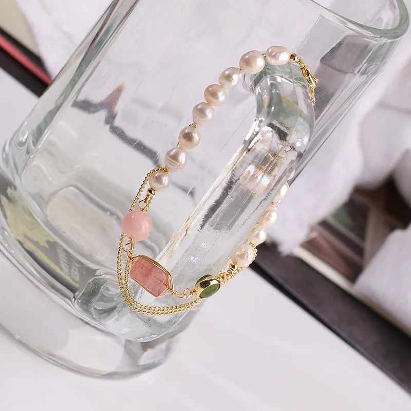 Women's freshwater pearl bracelet with strawberry quartz crystal charms in geometric wire wrap design