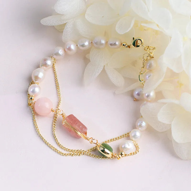 Women's freshwater pearl bracelet with strawberry quartz crystal charms in geometric wire wrap design