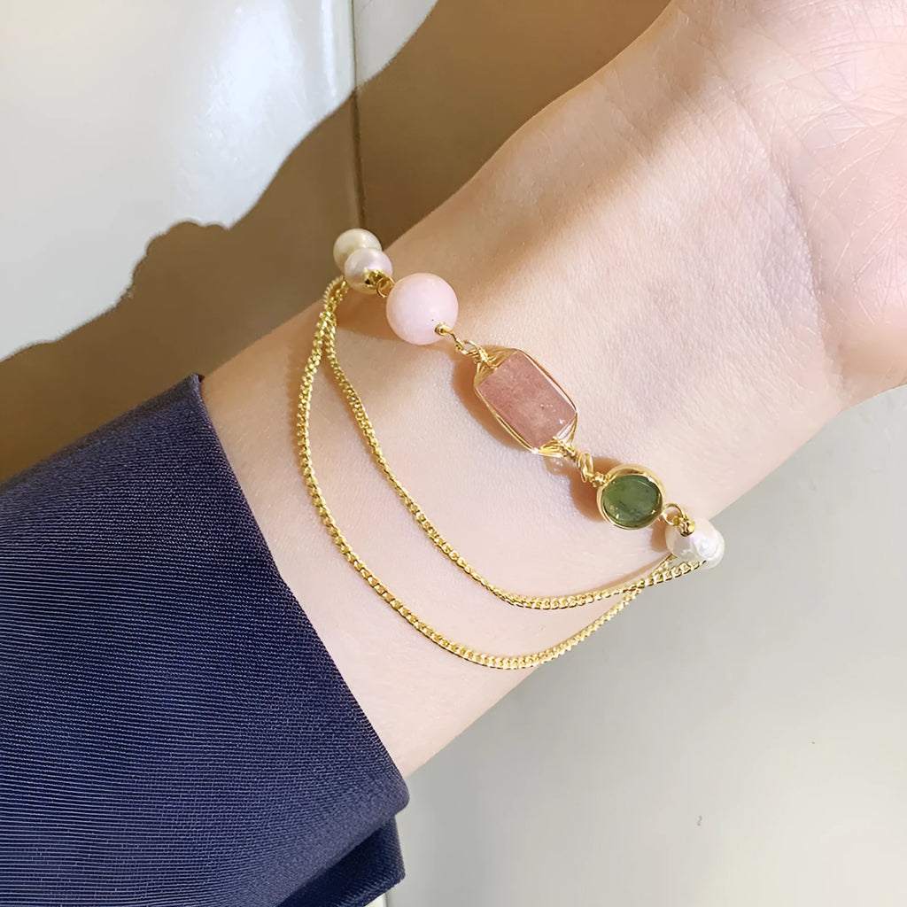 Women's freshwater pearl bracelet with strawberry quartz crystal charms in geometric wire wrap design