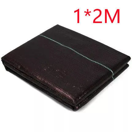 Black woven polyethylene weed-proof cloth laid flat on soil.