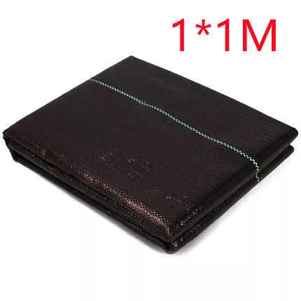 Black woven polyethylene weed-proof cloth laid flat on soil.
