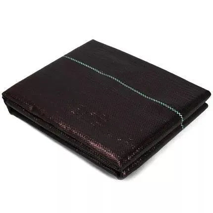 Black woven polyethylene weed-proof cloth laid flat on soil.