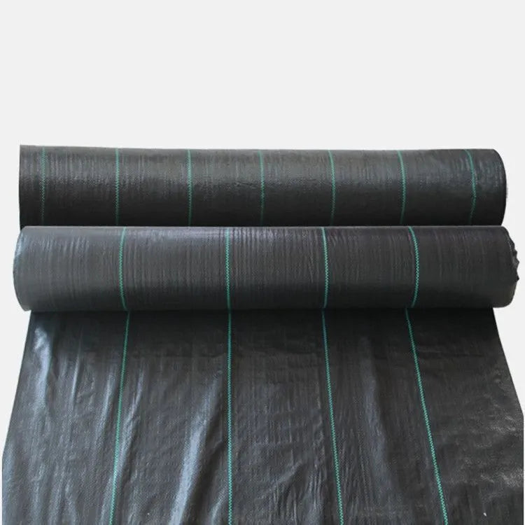 Black woven polyethylene weed-proof cloth laid flat on soil.