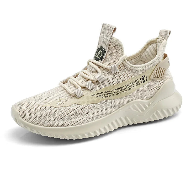 Men's low-top white mesh sports shoes with a rubber sole on a plain background.