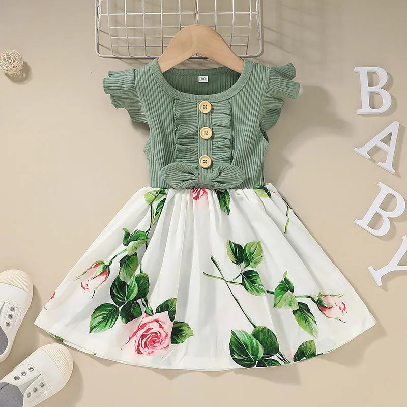 Sleeveless summer dress for a toddler girl on a hanger, shown in a green colour.