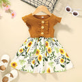 Sleeveless summer dress for a toddler girl on a hanger, shown in a green colour.