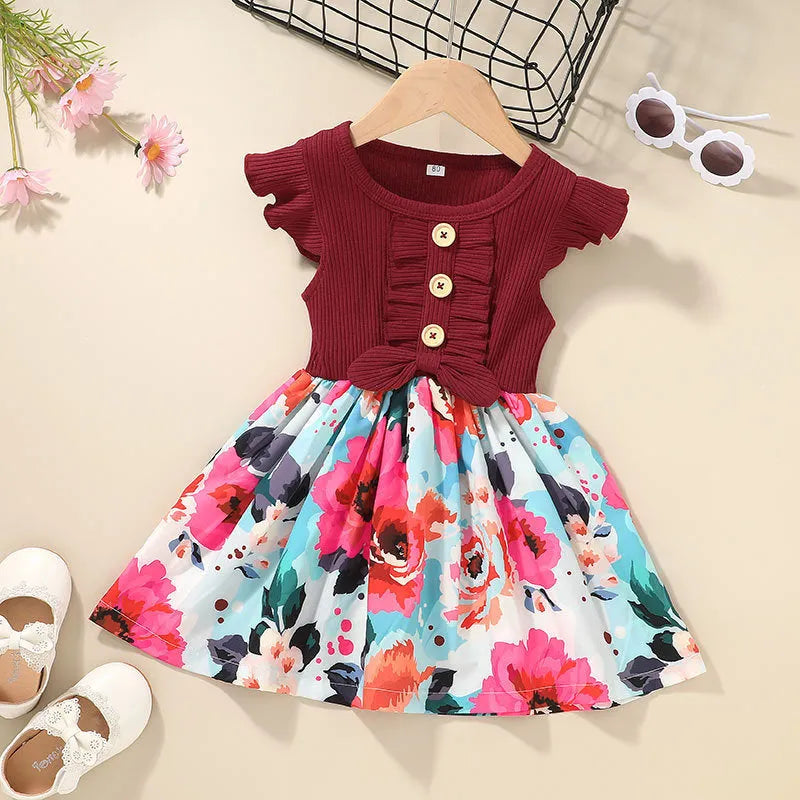 Sleeveless summer dress for a toddler girl on a hanger, shown in a green colour.