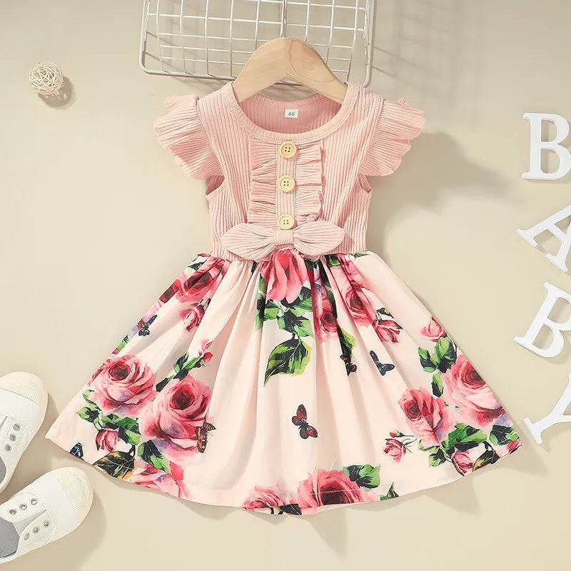 Sleeveless summer dress for a toddler girl on a hanger, shown in a green colour.