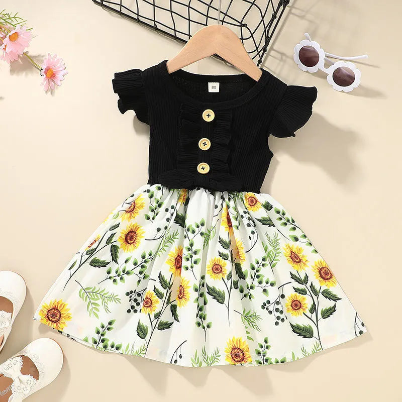 Sleeveless summer dress for a toddler girl on a hanger, shown in a green colour.
