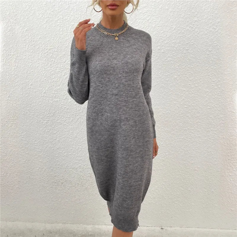 Grey women's crew neck long sleeve acrylic pullover sweater on a hanger