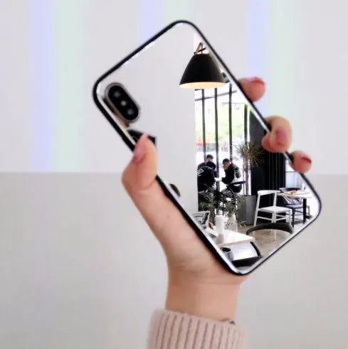 Black iPhone mirror phone case showing reflective back, compatible with iPhone X and 7/8 Plus models.