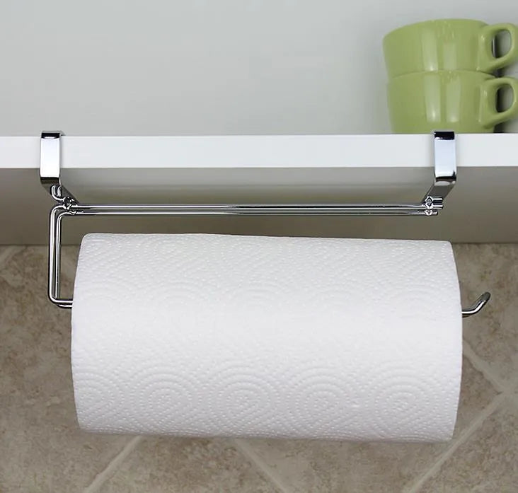 Silver stainless steel paper towel holder mounted on a kitchen cabinet door.