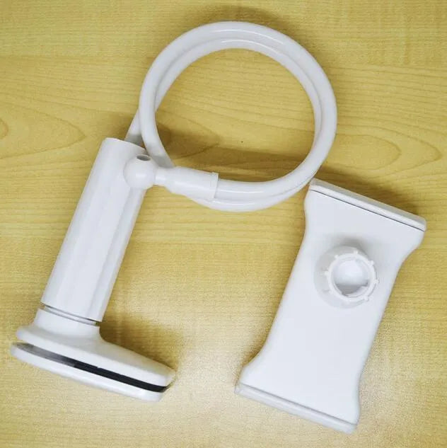 Black bedside oversize flat panel phone holder with a long arm mounted on a table.