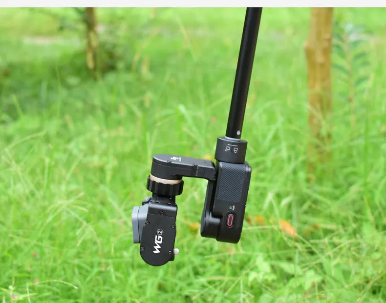 Black retractable selfie stick with phone bracket and anti-shake clip extended for use.