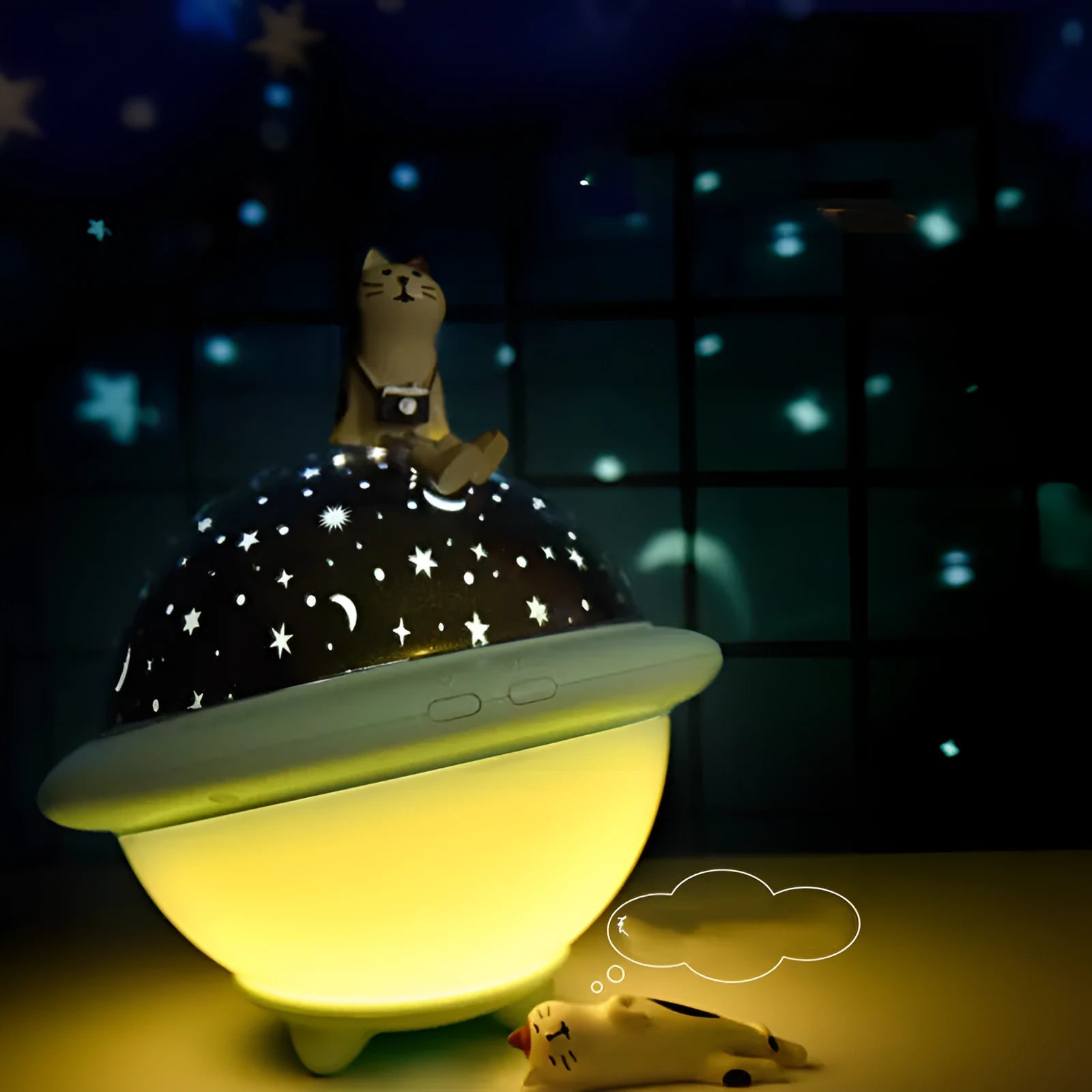 Pink UFO-shaped plastic LED night light projecting a starry sky pattern on a wall.