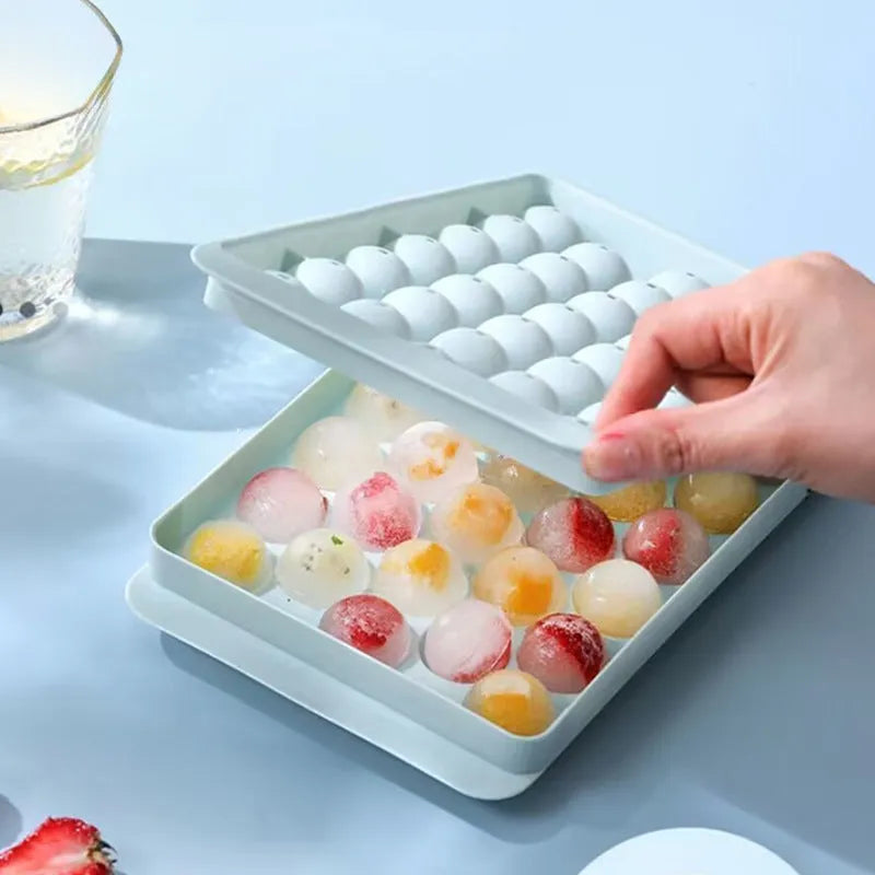 Blue silicone ice cube tray with lid showing 33 round moulds for homemade ice making