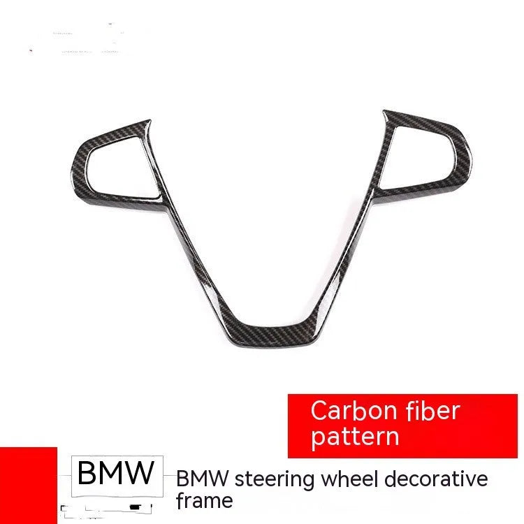 Carbon fibre pattern decorative frame for BMW steering wheel button trim.