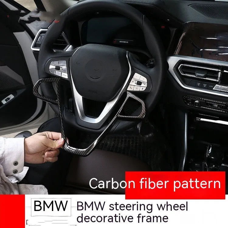 Carbon fibre pattern decorative frame for BMW steering wheel button trim.