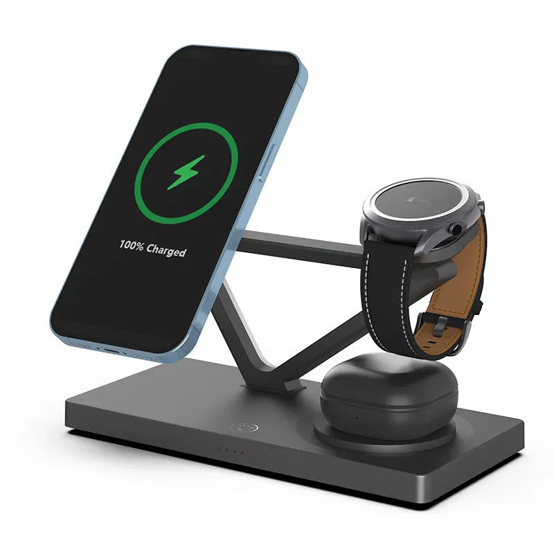 White 5-in-1 wireless charging station with magnetic phone holder, smartwatch pad, and glowing RGB night light on a wooden desk.