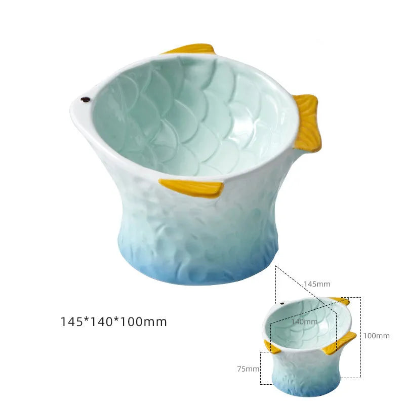 Blue fish-shaped ceramic cat bowl with elevated base and tilted food well
