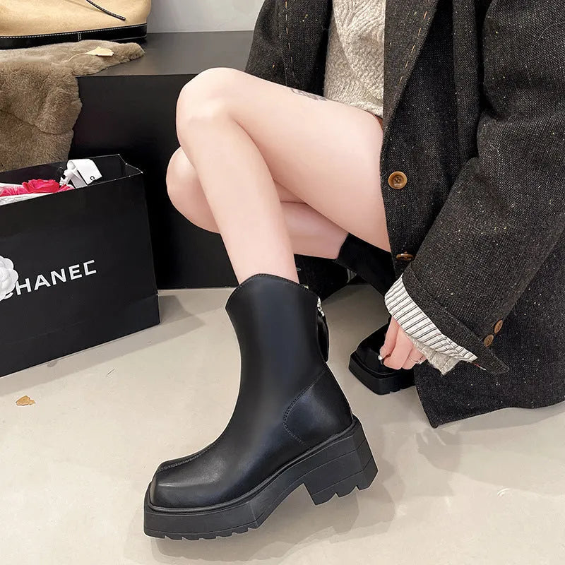 Black platform Martin boots for women with square toe and back zipper, shown on a white background.