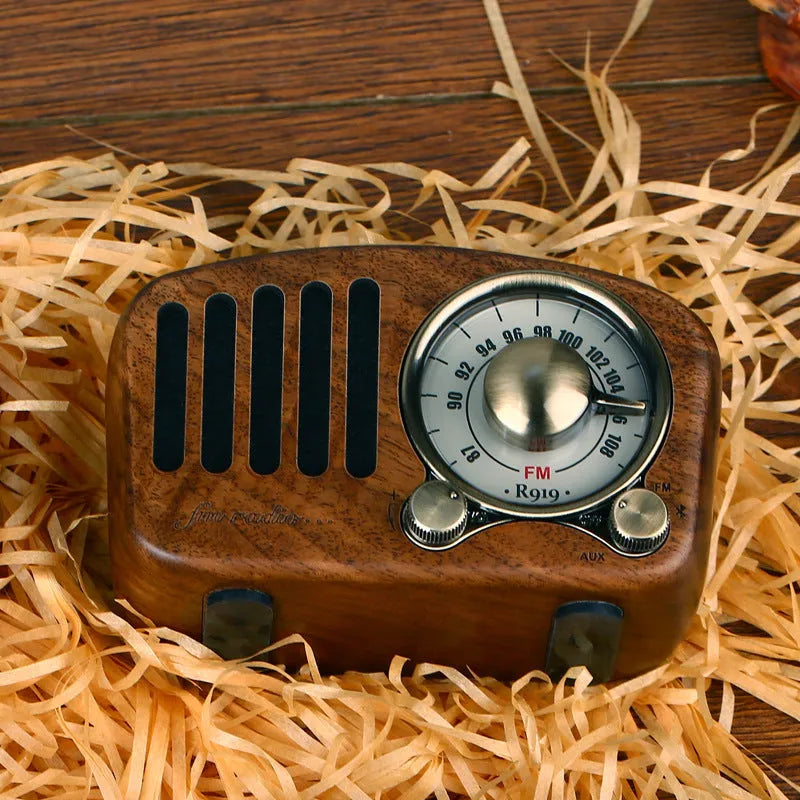 Retro wooden wireless mini Bluetooth speaker in cherry wood finish showing front speaker grille and controls