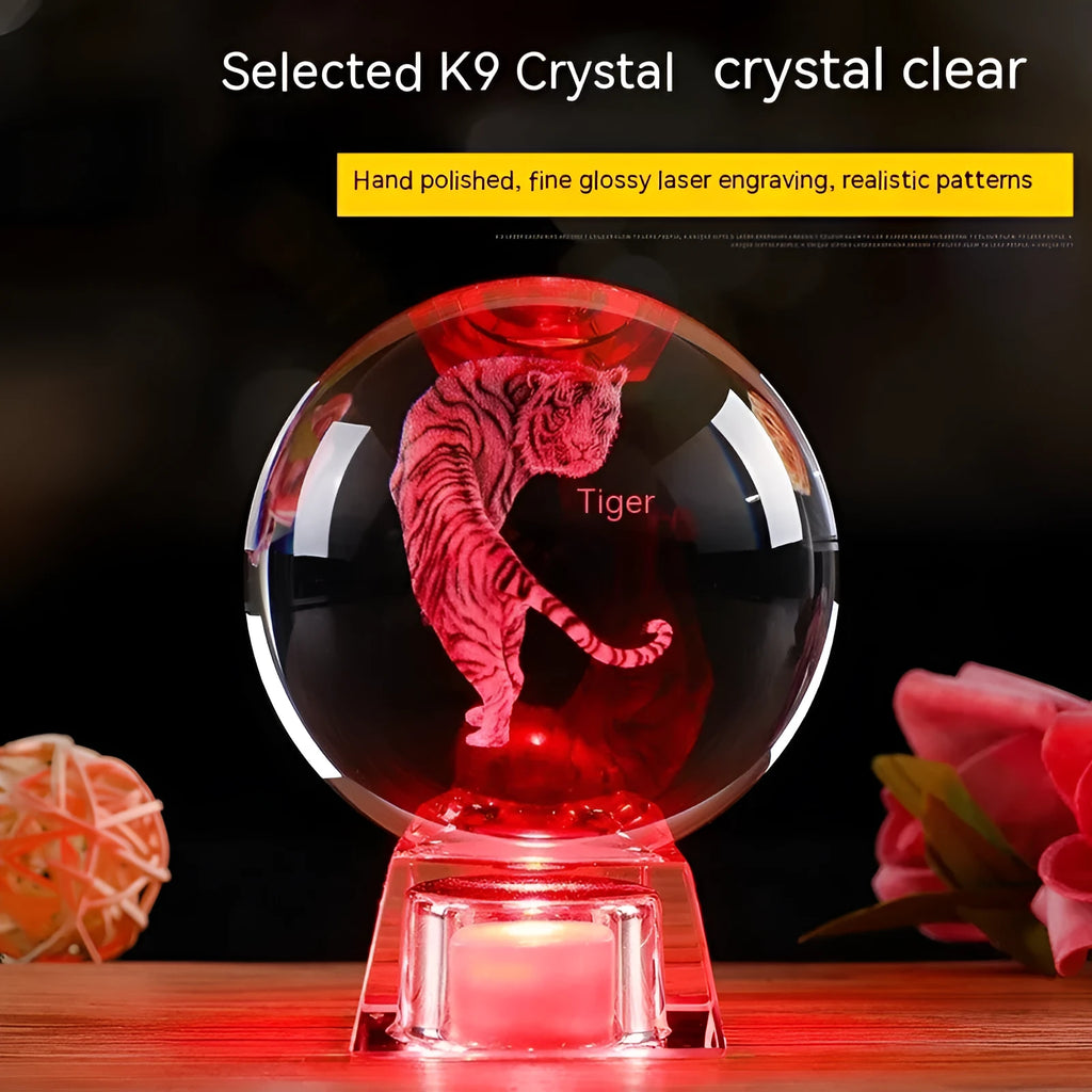 White luminous crystal ball ornament with Chinese zodiac animal figure on electronic base.